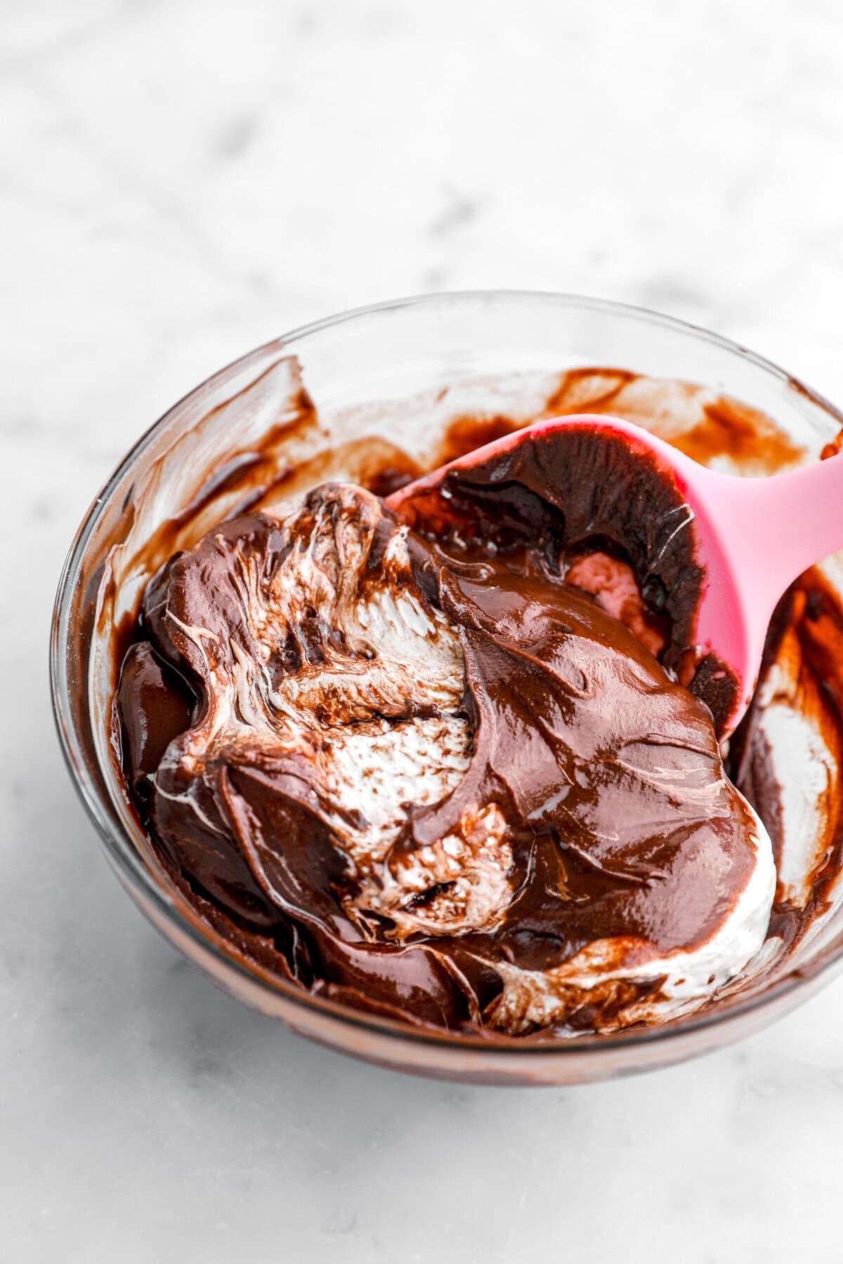 melted chocolate and marshmallow fluff being mixed together.